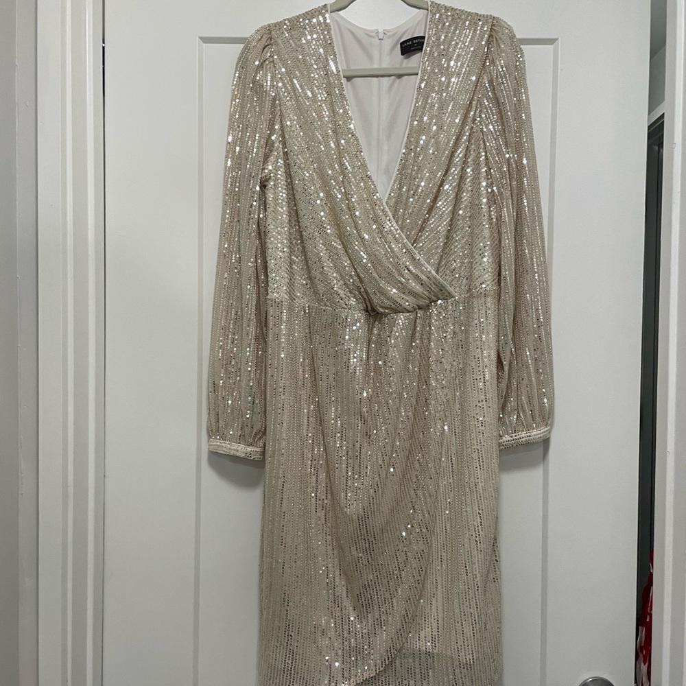 Never worn, beautiful and comfortable cream sequined faux wrap dress.